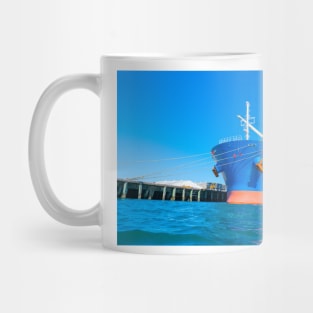 Large blue and red ship in port. Mug